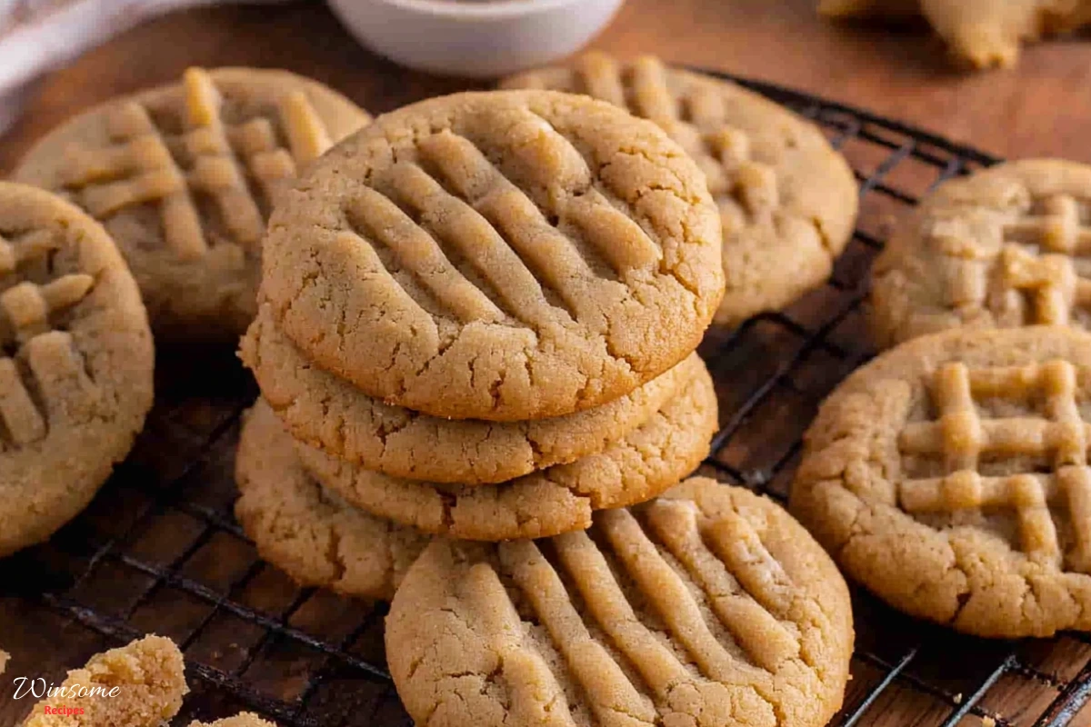 Peanut Butter Cookie recipe cooling on a rack, golden brown and delicious, ready to be enjoyed from a homemade recipe.
