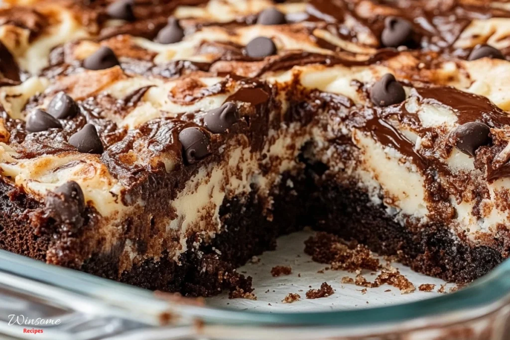 A close-up shot of a rich, moist earthquake cake in a glass baking dish. The cake features deep chocolate layers, swirls of cream cheese, and melted chocolate chips on top.