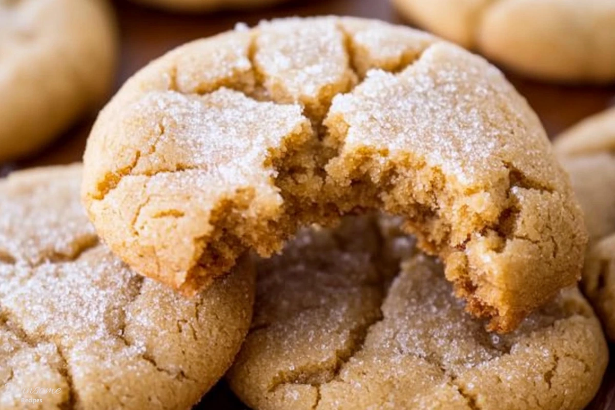 A close-up of a brown sugar cookie with a bite taken out, showcasing its soft texture and delicious golden color.
