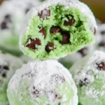 Mint Chocolate Chip Snowball Cookies dusted with powdered sugar, resembling mint chocolate chip snowballs.