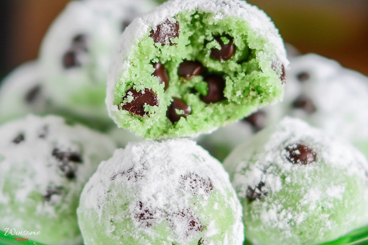 Mint Chocolate Chip Snowball Cookies dusted with powdered sugar, resembling mint chocolate chip snowballs.