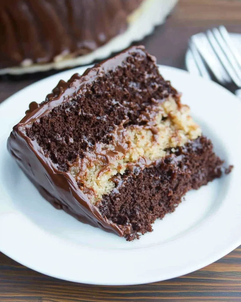 A slice of German chocolate cake on a white plate, showcasing rich chocolate layers and coconut frosting.