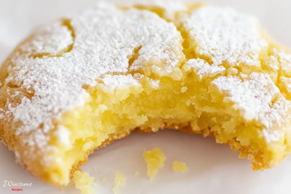 Lemon cookie dusted with powdered sugar, showcasing a delightful treat perfect for any dessert lover.