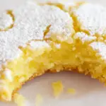 Lemon cookie dusted with powdered sugar, showcasing a delightful treat perfect for any dessert lover.