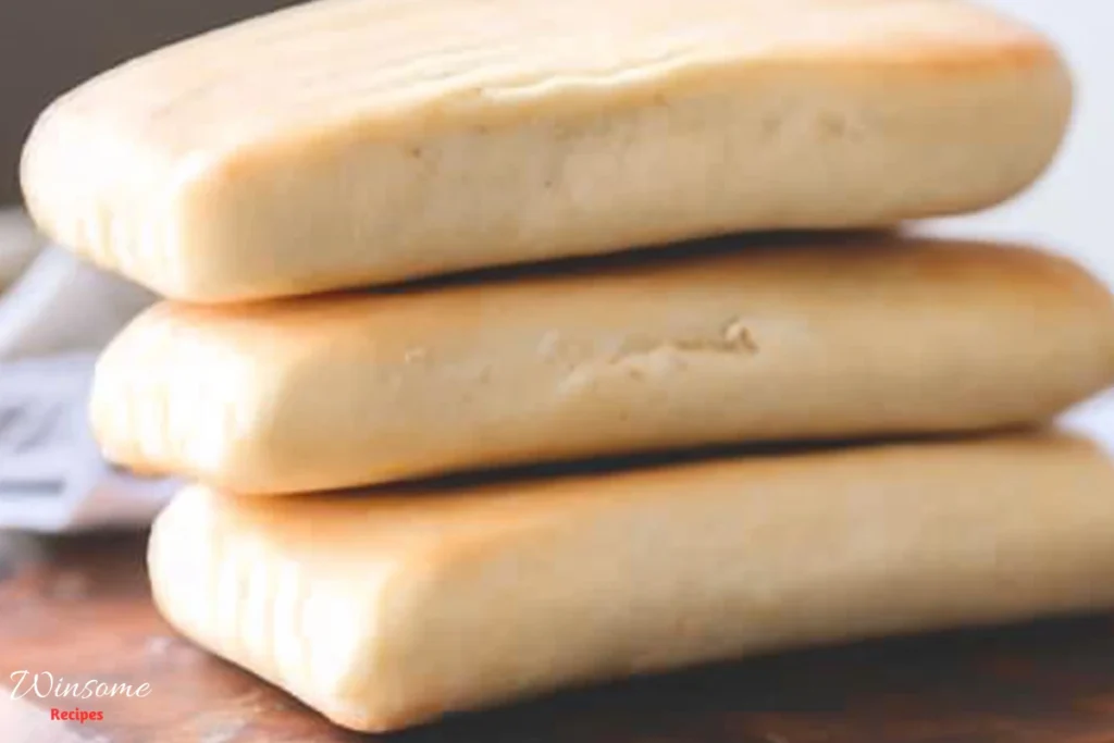 Three slices of panini bread arranged neatly on a rustic wooden board.