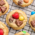 Strawberry and chocolate chip candy cookies cooling on a rack, showcasing a delightful blend of flavors in a tempting display.