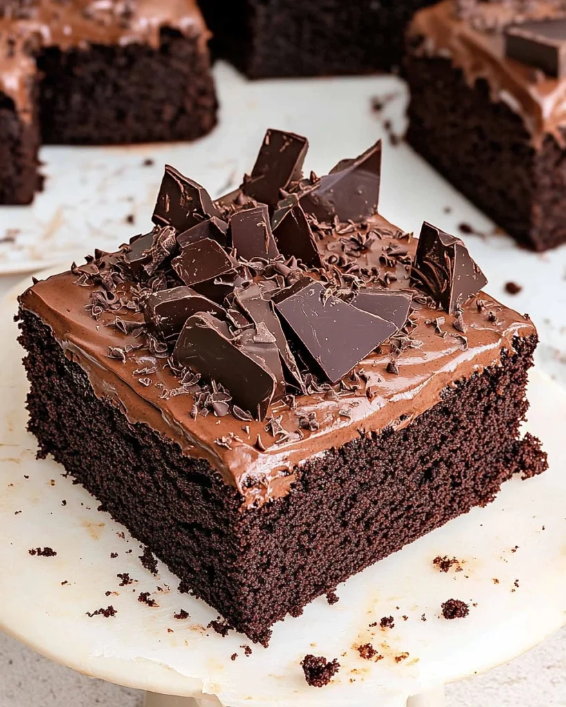Close-up of a slice of chocolate cake with rich chocolate frosting, featuring a hint of Dr Pepper flavor.