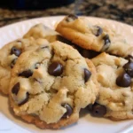 Grandma's chocolate chip cookies arranged on a white plate, showcasing their golden-brown color and chocolate chunks.